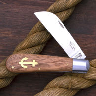 Otter Sapeli Wood Folder has stainless steel sheepsfoot blade, Sapeli scales with brass anchor inlay, made in Germany