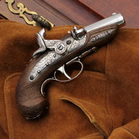 ornate replica baby Derringer cap gun has checkered wood resin handle, nickel metal parts, fires standard pull-off rings
