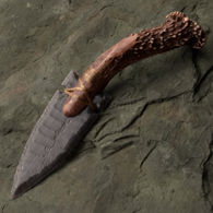 hand-knapped Fox Ear knife made in the USA with an obsidian blade, stag crown and bound with sinew, includes antler stand