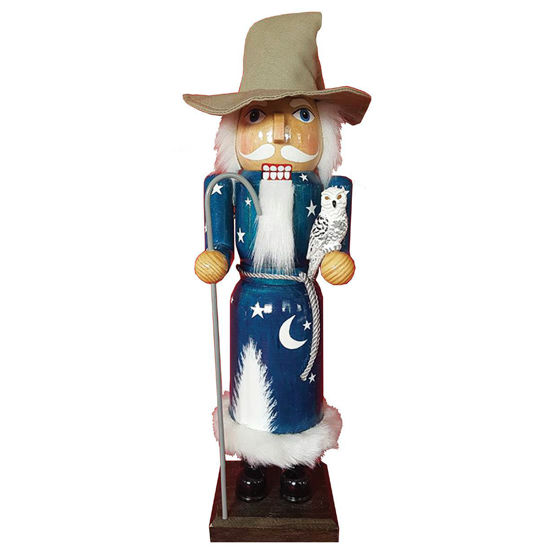 hand-crafted wooden Wizard Nutcracker has faux fur trim and hair, white owl sits on his left hand, Christmas tree on robe