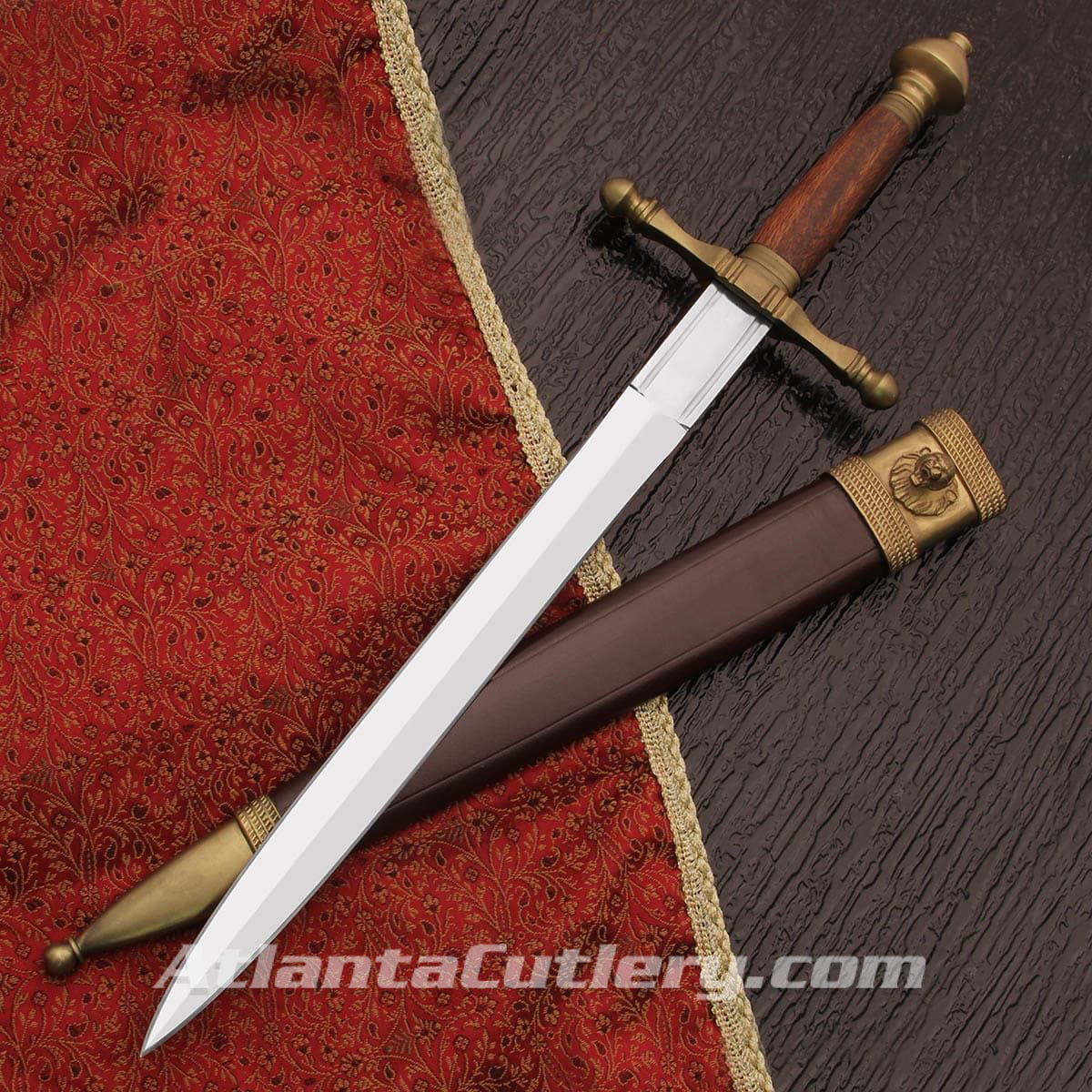 Bramham Moor Medieval Dagger by Windlass has high carbon steel blade, matte brass fittings and leather scabbard with lion's head