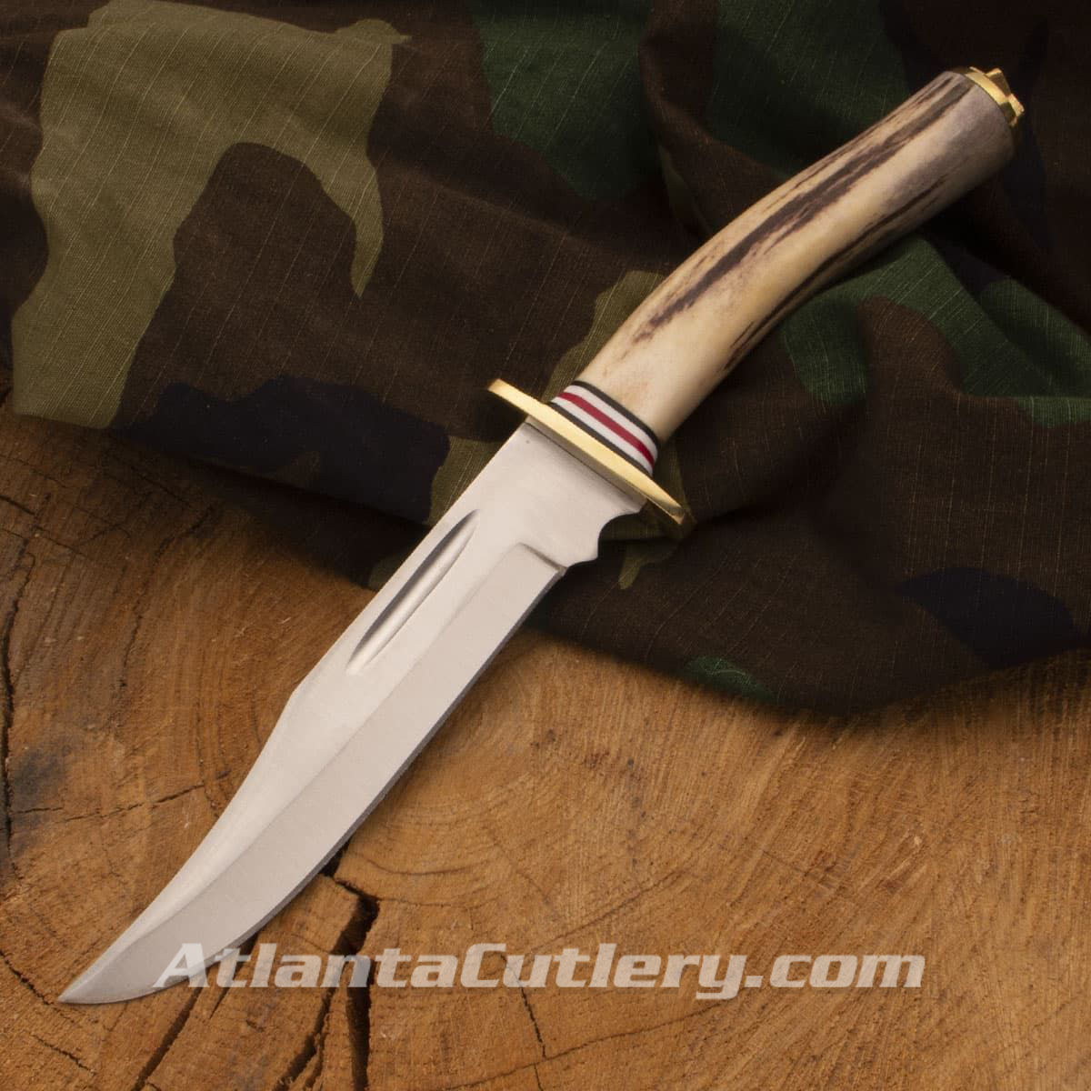 El Dorado hunting knife has solid brass pommel and guard, stag handle with black, white, and red spacers, leather belt sheath