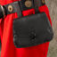 black leather pouch with leather toggle closure shown on belt