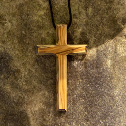 olive wood cross pendant handcrafted in Bethlehem using pruned limbs, then dried and carved to show the wood grain