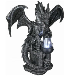 Dark Beacon Outdoor Solar light with cold cast resin winged dragon sits on a castle with a lantern in his mouth