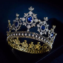 golden crown has thick metal construction, large, brilliant imitation sapphires and hundreds of imitation diamonds